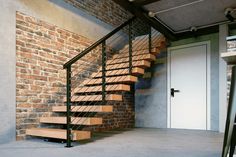 there is a stair case next to the door in this room with brick walls and stairs