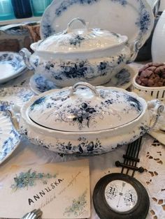 a table topped with plates and bowls filled with different types of dishes on top of a lace covered table cloth