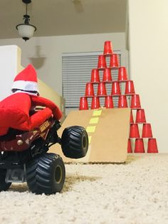 a santa clause riding on the back of a toy truck