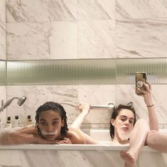 two women taking a selfie in the bathtub