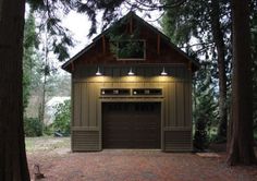 a garage in the woods with lights on it's roof and two doors open