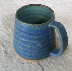 a blue mug sitting on top of a white counter