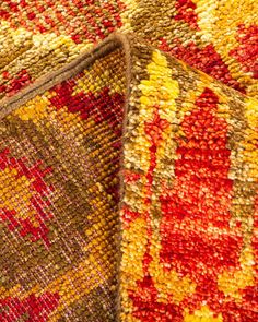 two different colored rugs on top of each other, one is red and the other is yellow