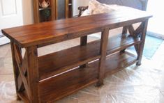 a wooden table sitting on top of a tiled floor