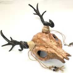 an animal made out of wood and rope with antlers on it's back