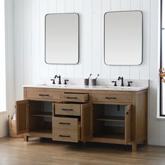 two mirrors are above the double sink vanity