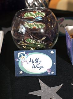 there is a candy bowl and business card on the table