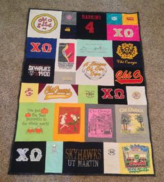 a quilt made out of t - shirts and other items is displayed on the floor