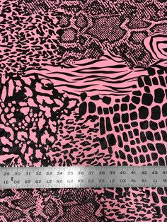 a pink and black animal print fabric with a ruler in the foreground, on a white background