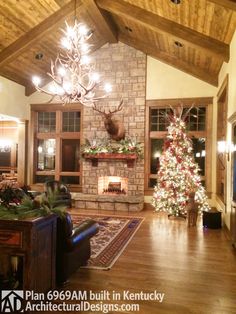 the living room is decorated for christmas and has a large tree with lights on it