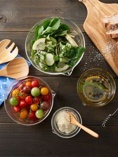 the table is full of different types of food and utensils, including bread