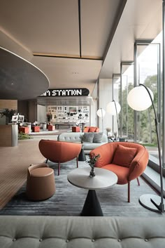 a living room filled with furniture and lots of windows