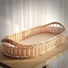 a wicker basket sitting on top of a wooden table