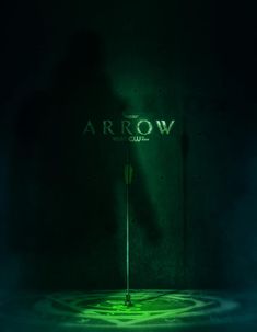 the arrow movie poster is lit up with green light in front of a dark room