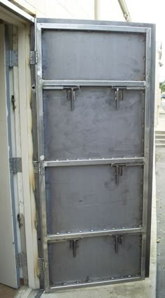 an open metal door on the side of a building