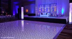 the dance floor is lit up with blue lights