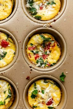 six muffins with different toppings on a baking sheet