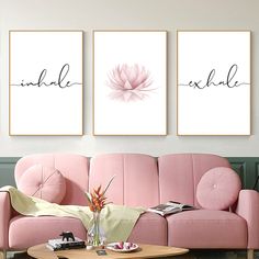 three pink couches in a living room with two paintings on the wall above them