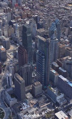 an aerial view of a city with skyscrapers and other tall buildings in the foreground