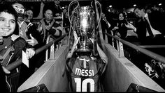 the messi trophy is displayed in front of some fans as they pose for a photo