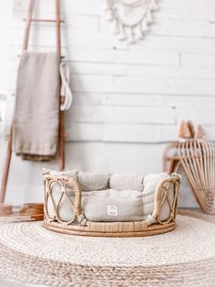 a wicker dog bed on top of a rug