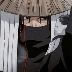 an anime character wearing a black outfit and holding a bamboo umbrella over his head, looking at the camera