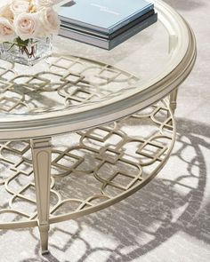 a glass table with flowers and books on it