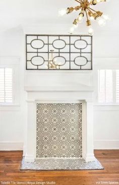 a living room with a fire place and a chandelier