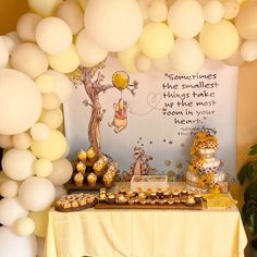 winnie the pooh birthday party with balloons and desserts