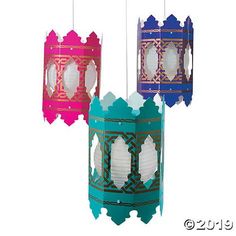 three paper lanterns hanging from strings on a white background, each with different designs and colors