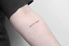 a person with a tattoo on their arm that says life and learn in black ink