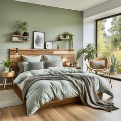 a bedroom with green walls and wooden furniture, including a large bed covered in grey linens