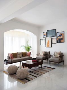 a living room filled with furniture and pictures on the wall