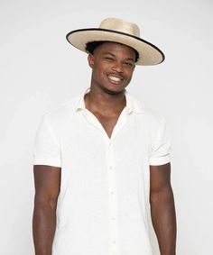 100% Palmilla Straw Authentic Feather Trim Bound Brim Edge Brim Size: 4" One Size Fits Most Resort Style Embrace timeless sophistication with the Peter Grimm Tarot Wide Brim Mexican Palm Straw Fedora Hat. Crafted from 100% Palmilla Straw, this hat exudes both durability and elegance. Its flat brim, measuring at a generous 4 inches, adds a sleek and distinctive touch to your ensemble. The hat features a refined grosgrain band and a leather overlay, embellished with an authentic feather trim, elevating its aesthetic appeal. A black bound brim edge further enhances its polished look. Not just a fashion statement, this hat also prioritizes functionality, offering UPF50+ sun protection, making it a reliable companion for sunny days. With its one-size-fits-most design, it ensures a comfortable a Mexican Palm, Straw Fedora Hat, Straw Fedora, Feather Trim, Resort Style, Fedora Hat, Grimm, Wide Brimmed, Polished Look