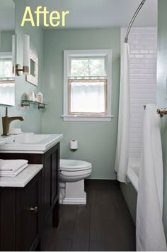 a white toilet sitting next to a bath tub in a bathroom under a sink mirror