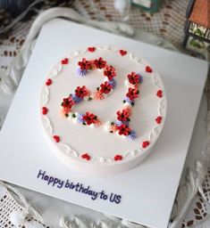 a white cake with red, white and blue sprinkles sitting on top of a table