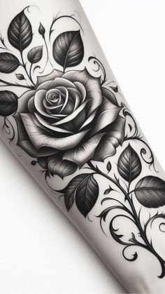 a black and white rose tattoo design on the right arm, with leaves around it