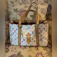 Pre Loved Limited Edition Louis Vuitton Takashi Murakami Aurelia Mm Tote Bag With Shopping Bag, Dust Bag And Luggage Tag. Everything Seen In Picture She Does Have Wear But Still In Beautiful Useable Condition. Please See All Pictures. This Was Shown Thoroughly On My Live Made In France Highlights White/Multicolour Signature Monogram Multicolour Canvas Leather Trim Two Long Top Handles Lobster Claw Fastening Main Compartment Internal Zip-Fastening Pocket With Replaced Zipper Pull Approximate Size Louis Vuitton Takashi Murakami, Limited Edition Louis Vuitton, Highlights White, Louis Vuitton Limited Edition, My Live, Takashi Murakami, Luggage Tag, Canvas Leather, Luggage Tags