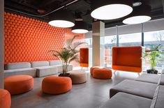 an orange and white living room with modern furniture