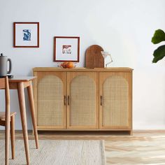 a wooden cabinet sitting next to a dining room table