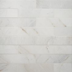 a white marble tile wall that looks like it has been cleaned