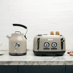 two toasters sitting on top of a counter