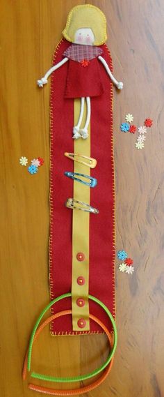 a red and yellow bag sitting on top of a wooden table next to a pair of scissors