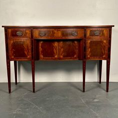 an antique wooden sideboard with three drawers