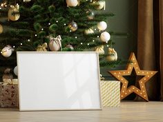 a christmas tree with presents under it and a white board in the foreground next to it