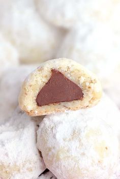 a cookie with a bite out of it sitting on top of some powdered sugar