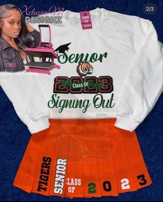 an orange skirt and white shirt with the words senior signing out printed on it next to a doll's head