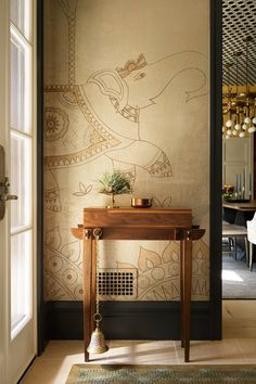 an entry way with a table and wallpaper