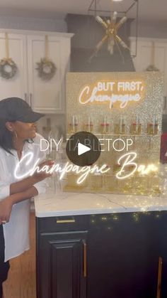 a woman standing in front of a counter with champagne bottles on it and the words, diy top champagne bar