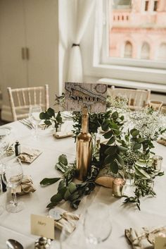 the table is set with flowers and place cards